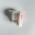 Dual-sided silicone face brush with off-white handle and pink massage bristles - White - With Lid + OPP Bag