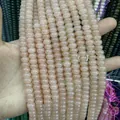 Light pink translucent natural stone rondelle beads held by hand for DIY jewelry making - Pink Aventurine / 5*8mm (approx. 73 pcs/strand)