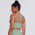 Close-up detail of mint green sports bra with elegant cross-back multi-strap design - Basil Green