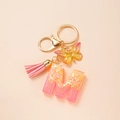 Fashionable pink glitter letter M keychain with gold butterfly and soft tassel detail - Letter M