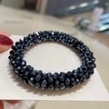 Detailed macro view of black faceted crystal beaded elastic hair tie and bracelet - Navy Blue