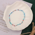 Handmade colorful seed bead bracelet with light blue and red accents on a shell tray - Style 6-Blue Red Clear Seed Beads