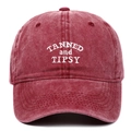Detail showing white embroidery TANNED and TIPSY on burgundy washed cotton baseball cap - Adjustable / Burgundy