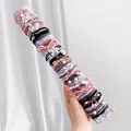 50-piece brown hair ties set with pearls and bows on a cylindrical display - Coffee Series Style B