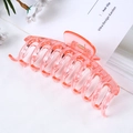 Detail of a large translucent pink hair claw clip featuring a sturdy metal spring - Jelly Transparent Pink