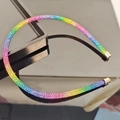 Detail of a thin rainbow rhinestone headband with gradient crystals and gold metal ends - Colorful Zirconia