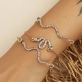 Dreiteiliges goldenes Schlangen-Armband-Set mit weißen Kristallen und grünen Steinaugen - Goldschlange Strass Set (2367)