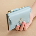 Short light blue PU leather quilted wallet for women with flower buckle and coin pocket - Blue