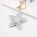 Close-up of silver PU leather star keychain with gold clip and white pearl detail - Silver Star