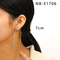 Close-up of model wearing 7cm oversized silver stainless steel hoop earrings - 7cm