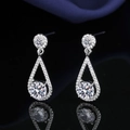 Elegant silver teardrop earrings with halo moissanite settings on a black mirror surface - Tassel Teardrop Earrings Led-89