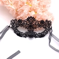Elegant black lace masquerade mask with silk ribbons on pink floral petals background - One Size / Black