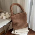 Detailed view of brown plush faux fur tote bag texture on cozy lifestyle background - Camel