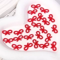 Detailed view of red pearl bead bowknot charms for DIY phone case crafts and decor - 1x1.8cm / Red