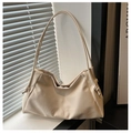 Detailed view of cream white tote bag with embossed logo and elegant knot shoulder strap - White