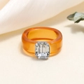 Chic transparent orange resin ring featuring a large rectangular crystal in a claw setting - One Size / Brown