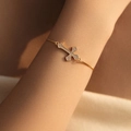 Adjustable gold plated cross bracelet for women with shimmering zircon butterfly accents - Minimalist Cross (KB0690)