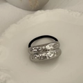 Close-up of a silver alloy hair tie with hammered rings on a white embossed plate - Hammered Style Silver