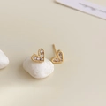 Macro shot of 18K gold heart earrings with zircon inlay on a white stone background - 18K Gold Plated Golden Tiny Heart Zirconia Studs