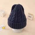Close-up of navy blue cable knit beanie with thick textured patterns and folded cuff - Navy Blue
