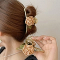 Detail of golden flower hair claw with beige rose and leaf on elegant updo hair - Champagne Rose Claw Clip