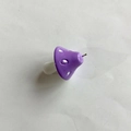 Macro detail of purple resin mushroom pendant with white spots and silver metal loop - Purple