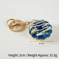 Realistic donut keychain in dark blue glaze with colorful sprinkles and gold clasp - 033 Blue - Gold 8-clasp