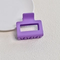 Detail view of square matte purple claw clip on textured background with ceramic plate - Matte Purple Small Square Claw Clip (6#)