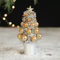 Mini 18cm silver Christmas tree with gold baubles and star on a white base stand - Gold & Silver Christmas Tree