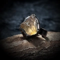Macro shot of raw yellow crystal stone on vintage textured metal ring setting - Citrine - Unpolished