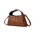 Detail view of brown leather square handbag with grainy texture and detachable strap - Caramel color