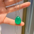 Elegant pear-cut green emerald pendant necklace with a fine silver-tone chain held by hand - Emerald Green Pear Pendant Only (Without Earrings)