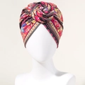 Bohemian vibrant red turban hat with colorful floral prints and a front swirl knot - Red