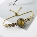 Macro shot of gold floral watch dial with crystal bezel and adjustable beaded bracelet - Rose Gold Coffee