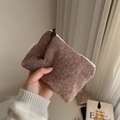 Close-up of brown herringbone mini pouch with soft wool texture and white zipper detail - Dark Red
