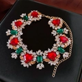 Close-up of heart red gemstone necklace with green accents and crystals on black leather - Necklace-Multicolor