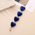 Close-up of blue velvet heart charms with golden metal edges and durable lobster clasps - K756 Heart Royal Blue Velvet