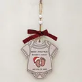 Wooden baby onesie Christmas ornament with red plaid bow and 2025 holiday greeting - Baby Onesie See You In 2025