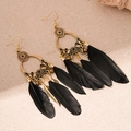 Detail shot of bohemian gold hoop earrings with black feather tassels and bead accents - Black Feather Ear Hook