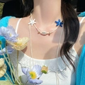 Detail of beach style necklace with blue starfish, natural shell and woven cord on model - 7# Blue White Starfish Shell Woven Necklace
