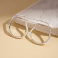 Detail of silver irregular organic earrings on marble stone with a matte finish - Silver