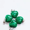 Set of four 15mm green striped heart stone pendants with metal bails on white background - Synthetic Malachite