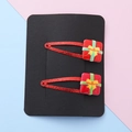 Set of two red glitter Christmas gift box hair clips with festive resin bow ornaments - Gift