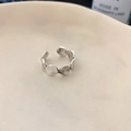 Detail of vintage silver open ring with irregular hammer texture on a ceramic dish - Irregular Hammered Style / Silver