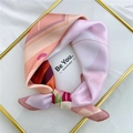 Silk scarf with abstract pink and orange patterns folded on a white fabric background - 53cm / 17 Couple Waving