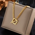 Elegant gold cuban link necklace with square toggle clasp on a beige jewelry box - Cuban Chain Square T-Clasp Design (N1086)