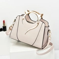 Elegant beige handbag with golden cat-ear metal handles and a detachable shoulder strap - White