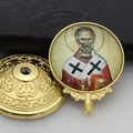 Detailed view of the gold-framed religious saint icon and decorative metallic base - Gold-14 (St. Nicholas Ornament)
