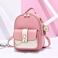 Pink and beige PU leather backpack with gold chain detail and daisy charm on a geo background - Pink