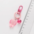 Lollipop keychain detail showing pink bell and dimensions on a clear scale ruler - Rose Red